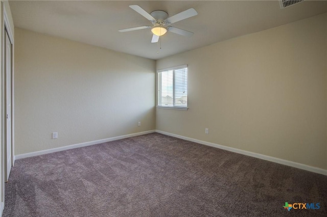 empty room featuring carpet floors and ceiling fan