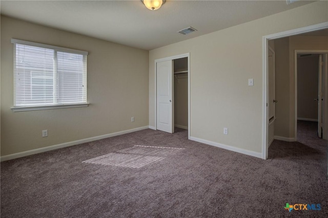 unfurnished bedroom with carpet flooring and a closet