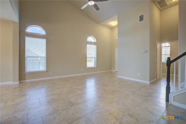 spare room featuring ceiling fan, high vaulted ceiling, and plenty of natural light