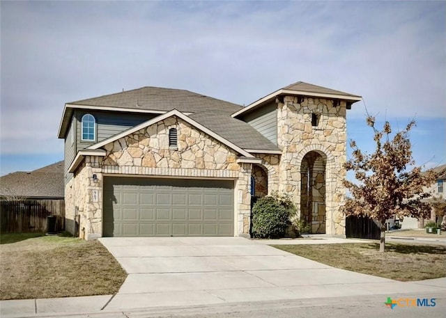 view of front of home featuring a garage and central AC unit