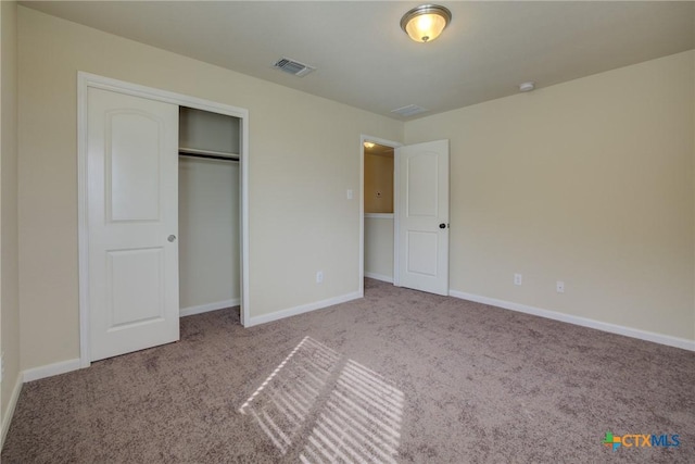 unfurnished bedroom with carpet and a closet