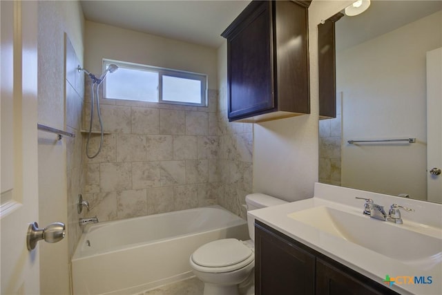 full bathroom with tiled shower / bath combo, toilet, and vanity