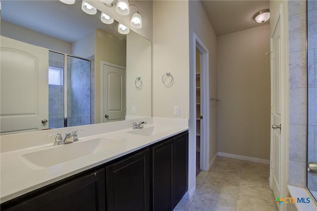 bathroom with a shower with door and vanity