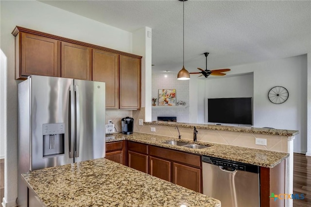 kitchen with sink, pendant lighting, dark hardwood / wood-style floors, ceiling fan, and stainless steel appliances