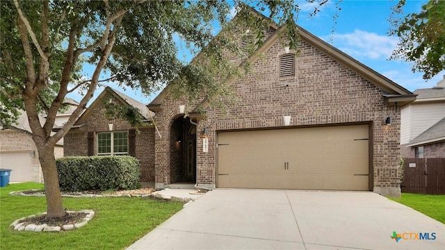 view of front of property with a garage and a front lawn