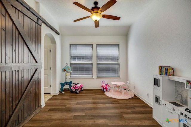 rec room with ceiling fan and dark hardwood / wood-style floors