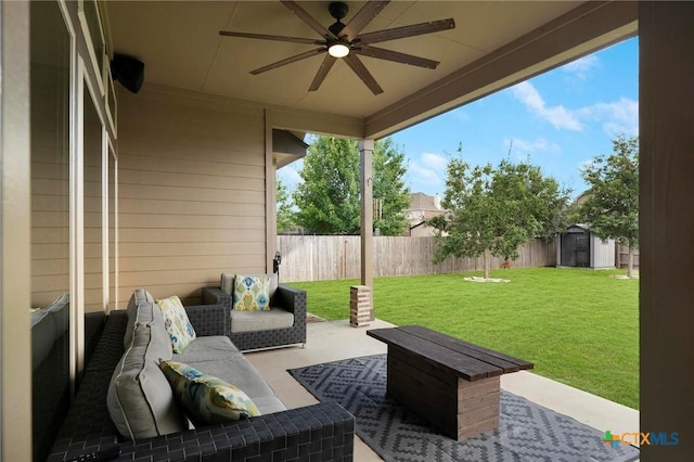 view of patio with an outdoor living space, ceiling fan, and a shed