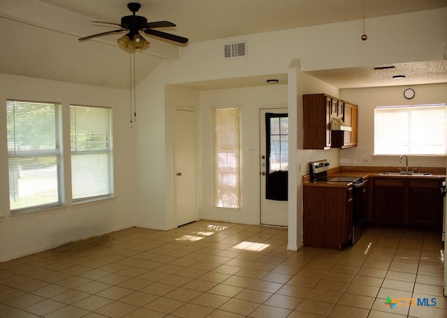 kitchen with ceiling fan, stainless steel electric stove, sink, lofted ceiling with beams, and light tile patterned flooring