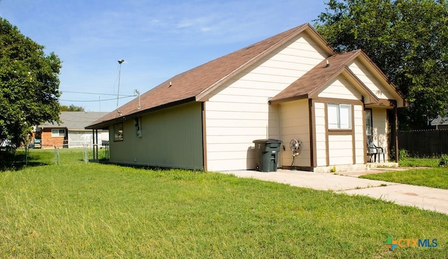 view of property exterior with a lawn