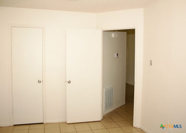 unfurnished bedroom featuring light tile patterned floors