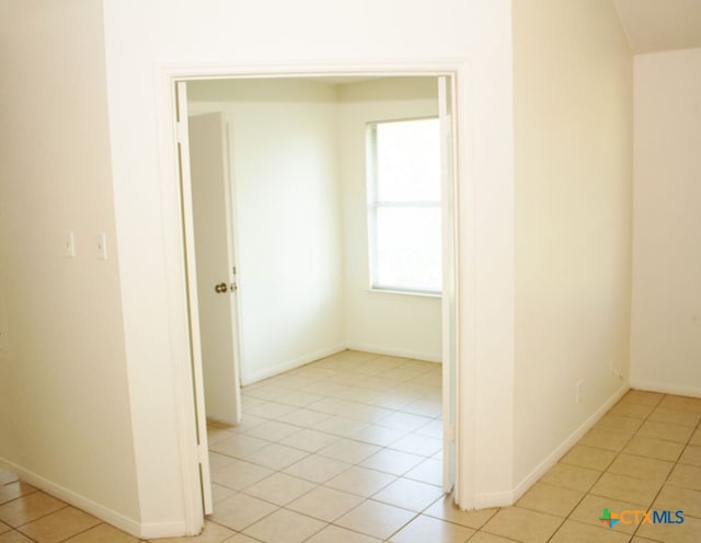 corridor featuring light tile patterned floors