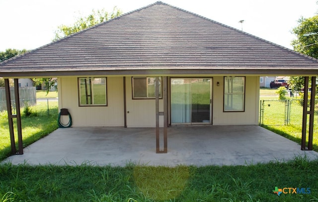 back of house featuring a patio area and a yard