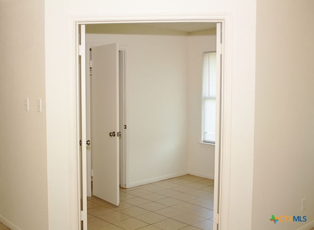 hallway with light tile patterned floors