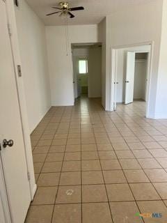 tiled empty room with ceiling fan