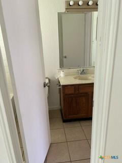 bathroom featuring tile patterned flooring and vanity