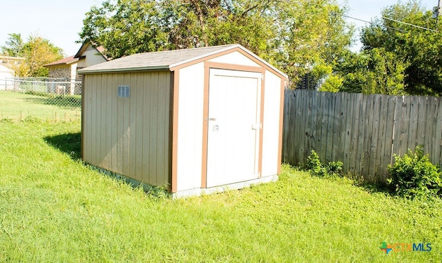 view of outdoor structure featuring a lawn