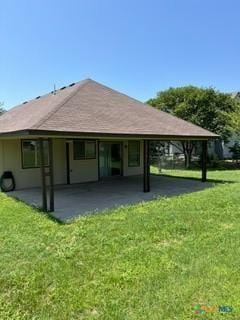 rear view of house with a yard