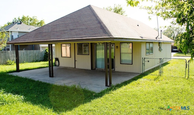 rear view of house featuring a yard and a patio