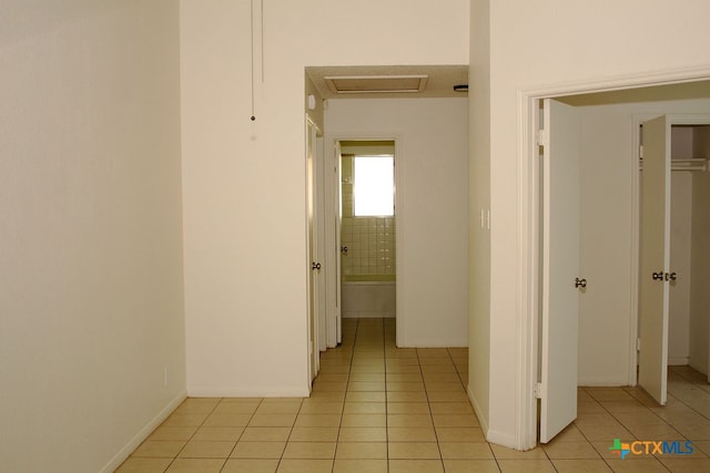 hall featuring light tile patterned floors