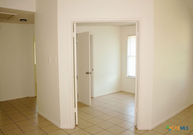 hallway featuring light tile patterned floors