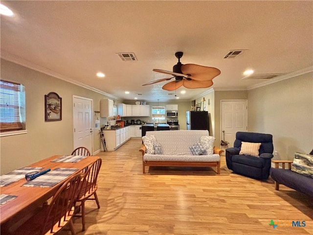1306 W Madison Ave, Port Oconnor, TX 77982 - living area with light wood finished floors, crown molding, a ceiling fan, recessed lighting, and a textured ceiling