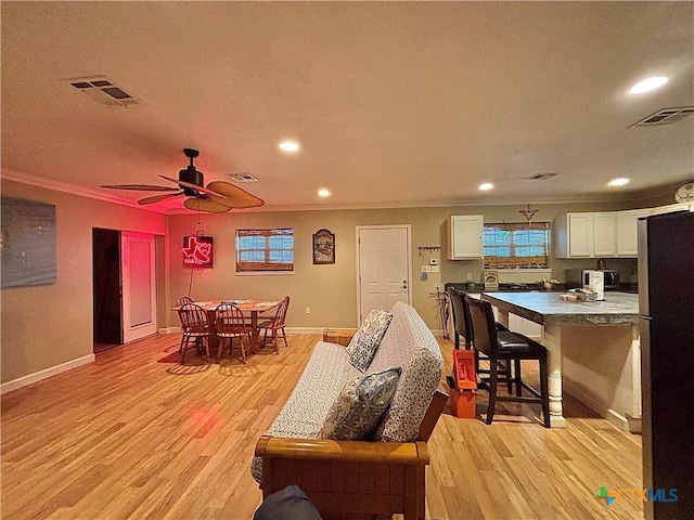 1306 W Madison Ave, Port Oconnor, TX 77982 - living area with crown molding, light wood-style floors, recessed lighting, baseboards, and a ceiling fan