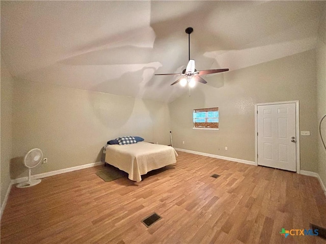 1306 W Madison Ave, Port Oconnor, TX 77982 - unfurnished bedroom with vaulted ceiling, light wood finished floors, and baseboards