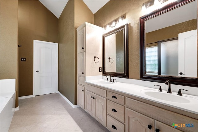 110 Agua Verde, Seguin, TX 78155 - bathroom with a textured wall, double vanity, a garden tub, tile patterned flooring, and baseboards