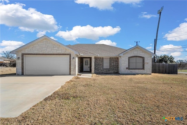 ranch-style house with a garage and a front lawn