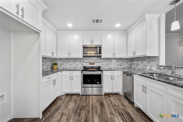 kitchen featuring pendant lighting, sink, stainless steel appliances, and white cabinets