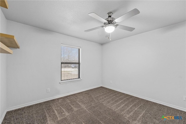 carpeted empty room featuring ceiling fan and a textured ceiling