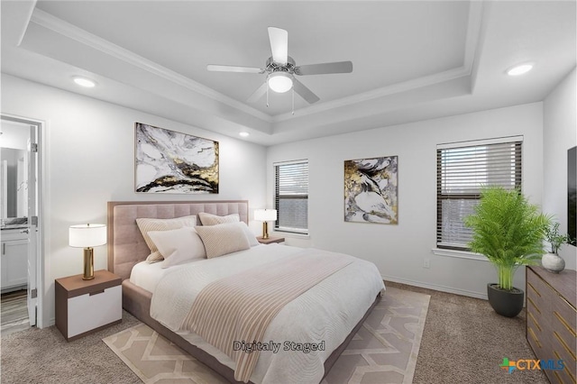 carpeted bedroom featuring ceiling fan, ornamental molding, and a raised ceiling