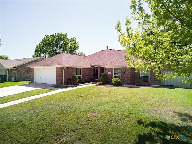 single story home with brick siding, a garage, a front yard, and concrete driveway