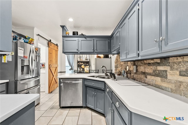kitchen featuring stainless steel appliances, light countertops, gray cabinetry, light tile patterned floors, and crown molding