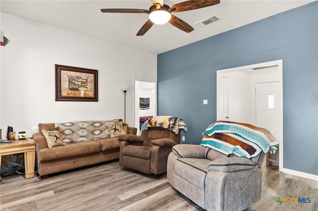 living area featuring a ceiling fan and wood finished floors