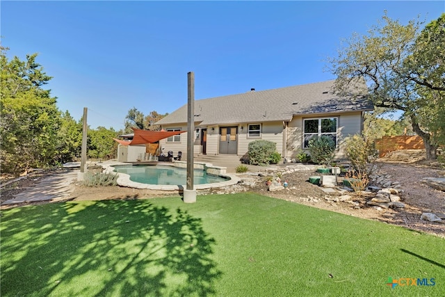 back of house with a yard and a patio