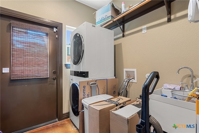 laundry area featuring stacked washer and dryer