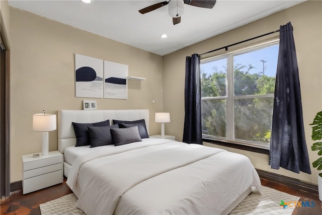 bedroom featuring ceiling fan and dark hardwood / wood-style flooring