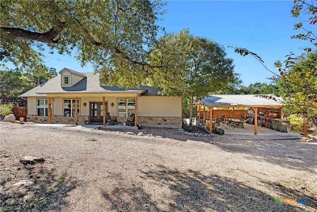 view of front facade featuring french doors and a patio