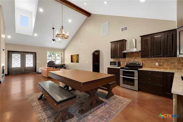 dining space featuring beam ceiling, a skylight, ceiling fan, and high vaulted ceiling