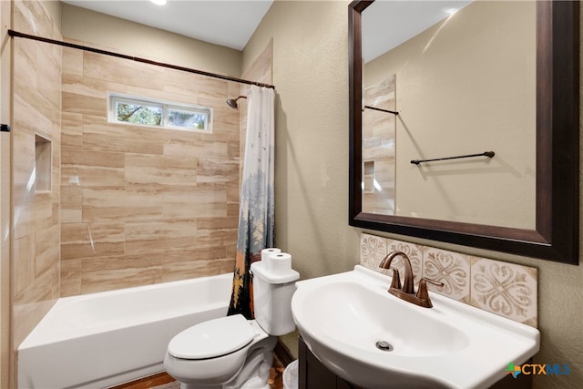 full bathroom featuring toilet, shower / bath combo with shower curtain, and sink