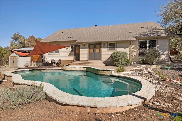 view of pool featuring a storage shed