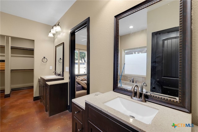 bathroom with vanity and concrete flooring