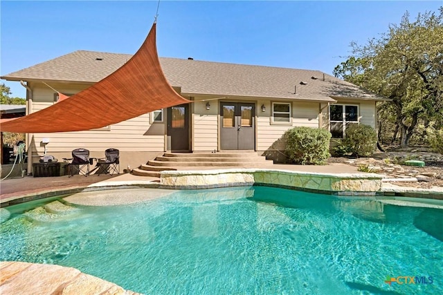 view of pool with french doors and a patio area