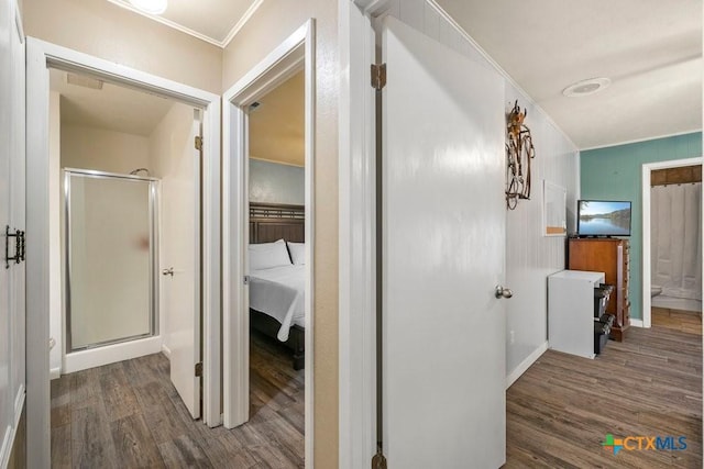 hall with dark hardwood / wood-style flooring and crown molding