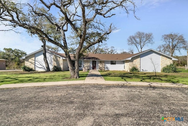 ranch-style house with a front lawn