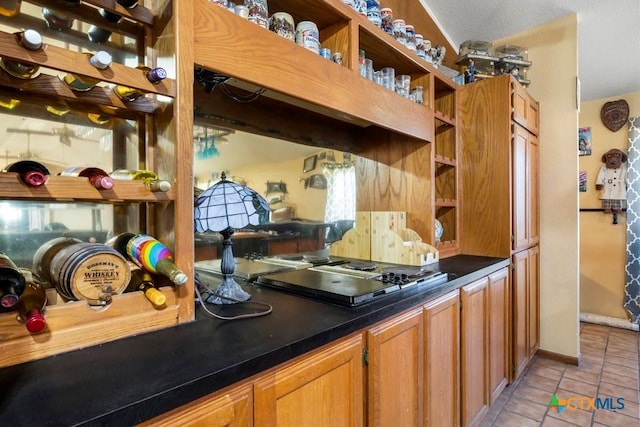 kitchen with stainless steel gas cooktop and light tile patterned flooring