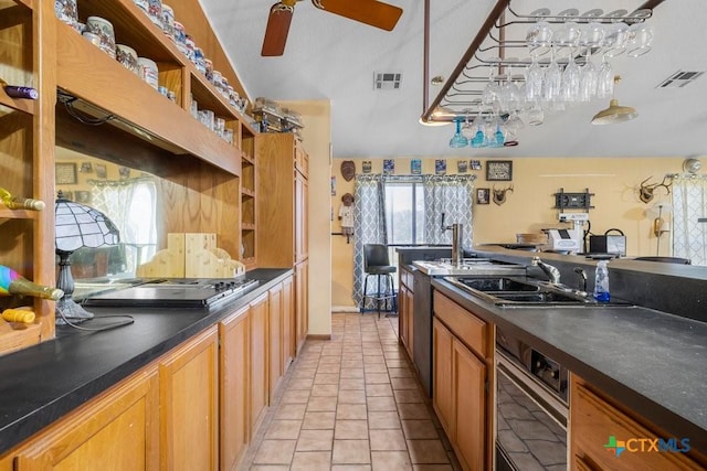 kitchen with ceiling fan, light tile patterned floors, stainless steel gas cooktop, and sink