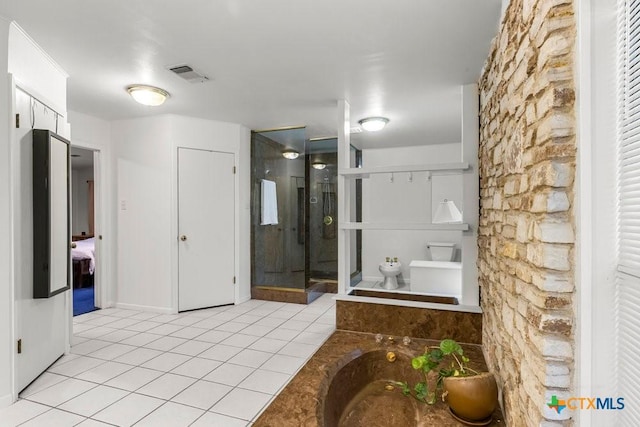 bathroom with toilet, tile patterned floors, and shower with separate bathtub