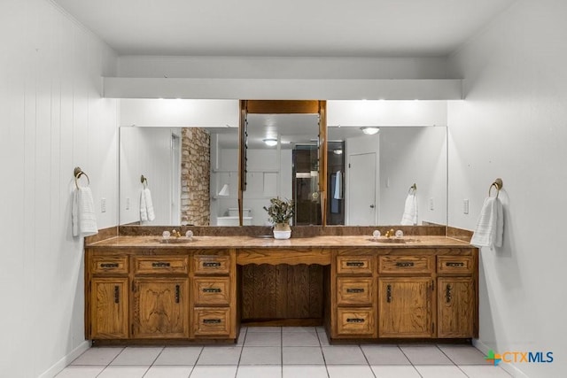 bathroom with tile patterned flooring and vanity